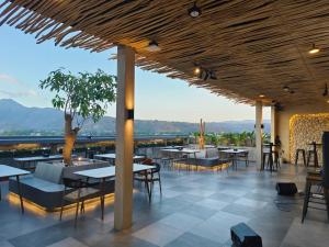a restaurant with tables and chairs and a view at Kaloka City Hotel Bima in Bima