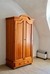 a wooden cabinet in a room with an attic at Historic Flat & Private Courtyard in Bruck an der Leitha