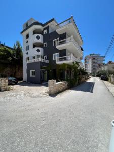a large building on the side of a road at Villa Sopebra in Sarandë