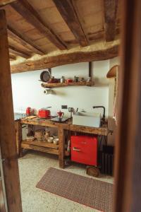 a kitchen with a counter and a red refrigerator at Tenuta del Picchio in Colombara