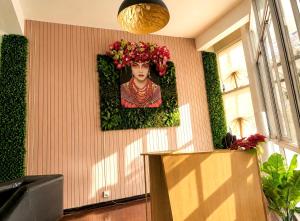 a wall with a picture of a woman with flowers on it at Cocohouse Sukhumvit 1 in Makkasan