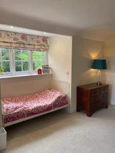 a bedroom with a bed and a dresser and a window at Thorn Tree Garth in Coulton