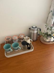 a tray with cups and other dishes on a table at Thorn Tree Garth in Coulton