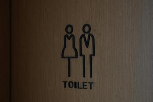 a toilet sign with two people on it at DAI HOSTEL Ayase in Fukaya