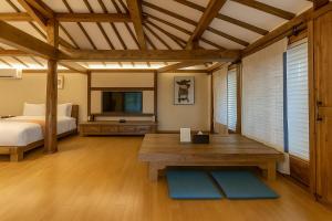 a bedroom with a bed and a table in a room at The Seaes Hotel & Resort in Seogwipo