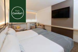 a bedroom with a bed and a flat screen tv at Sercotel Delfos Andorra in Andorra la Vella