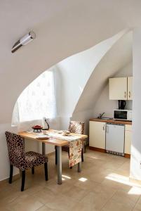 a kitchen and dining room with a table and chairs at Historic Flat & Private Courtyard in Bruck an der Leitha