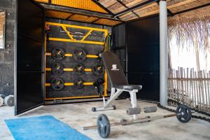a gym with a chair in front of a wall at Sea Shells Beach Resort Agatti in Agatti +70 photos