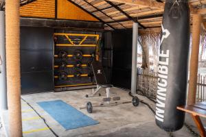 a gym with a chair and a dumbbell rack at Sea Shells Beach Resort Agatti in Agatti