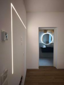 a white bathroom with a mirror and a sink at L'Albero del Tempo in Falze