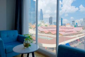 a room with a view of a city from a window at Ngan Ha Hotel - Ben Thanh Central in Ho Chi Minh City