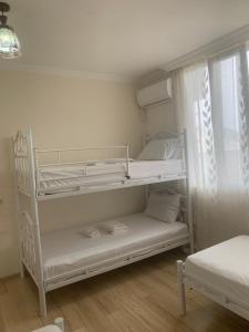 a room with two bunk beds and a window at LouNik stay hotel and rooms in Kobuleti +101 photos