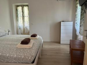 a bedroom with a bed and a dresser in it at La Bella e La Bestia in Lierna