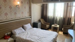 a hotel room with a bed and a window at Chwar chra hotel in Erbil