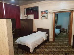 a hotel room with two beds and a window at Chwar chra hotel in Erbil