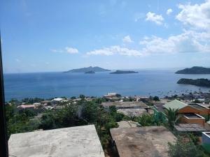 a view of the ocean with islands in the distance at Entre Ciel et Lagon in Mtsamboro