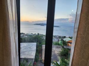a window with a view of a city at Entre Ciel et Lagon in Mtsamboro