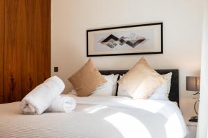 a bedroom with a bed with white sheets and pillows at Metropole Hotel in London