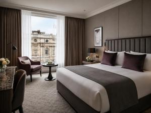 a hotel room with a large bed and a window at Metropole Hotel in London
