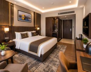 a bedroom with a large bed and a living room at the glory stay in Amritsar