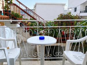 a white table and two chairs on a balcony at Galatas home in Galatas