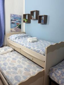 two twin beds in a room with at Da Michele. in Costa Rei