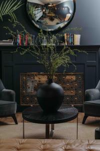 a black vase sitting on a table in a living room at La França Hotel Boutique in Barcelona