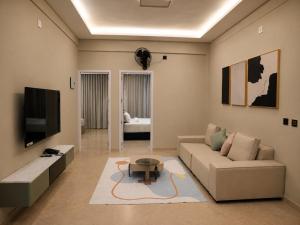 a living room with a couch and a coffee table at Le Venzia in Sultan Bathery