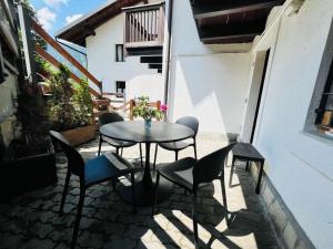 a table and chairs sitting on a patio at GuestHost - Mulino del Bianco - Comfy Studio-Flat in La Thuile +12 photos