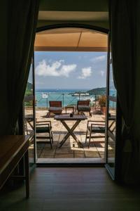 an open door to a patio with a table and chairs at Miramare Apartments&Suites in La Spezia +20 photos