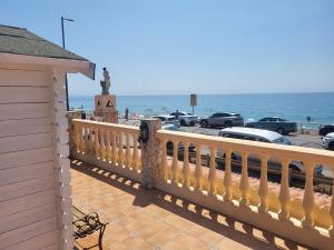 a yellow fence next to a parking lot next to the ocean at La Casita del Mar in Torrox