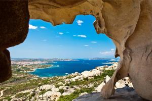 a view of the ocean through a rock formation at Hotel with breakfast included in Palau in Proiettore