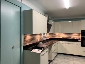 a kitchen with white cabinets and a counter top at La Catalane in Perpignan