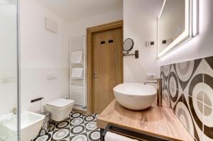 a bathroom with a white sink and a toilet at Holiday IV Gardan in Riva del Garda +84 photos
