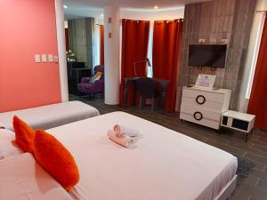 a bedroom with two beds with a baby doll on it at Green Monkey Resort Boracay in Boracay +38 photos