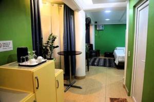 a room with a room with a green wall at Green Monkey Resort Boracay in Boracay