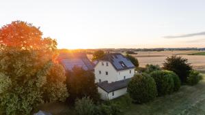an aerial view of a white house with trees at Ferienhof Häckler in Ochsenhausen