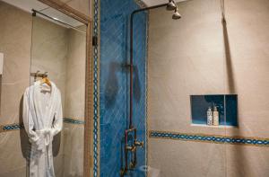 a shower with a glass door in a bathroom at Riad Mazal Mogador in Essaouira