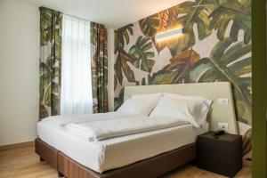 a bedroom with a bed with a painting on the wall at Holiday IV Gardan in Riva del Garda