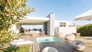 a backyard with a swimming pool and a house at Horizon House in Mossel Bay