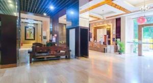 a lobby with a bench in the middle of a building at Behito Hotel in Dongguan