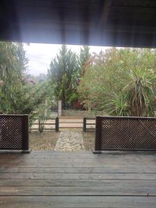 two benches sitting on top of a wooden deck at Lada Bojana in Ulcinj