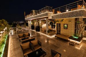 an outdoor patio with couches and tables at night at Aman Homestay, A Boutique Hotel in Agra