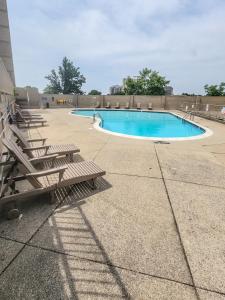 a swimming pool with lounge chairs at The River Condos in Detroit