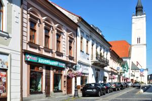 a city street with buildings and cars parked on the street at Centrum Comfort Apartment in Rimavská Sobota