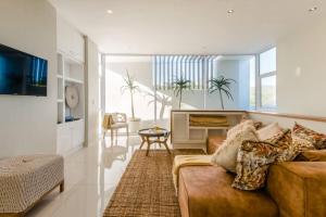 a living room with a couch and a table at White Water Retreat - Pinnacle Point in Mossel Bay