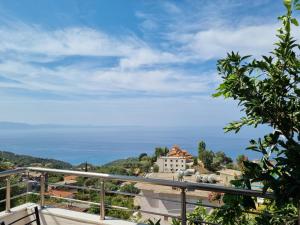 a view of the ocean from the balcony of a house at Let Rooms Lukova in Lukovë