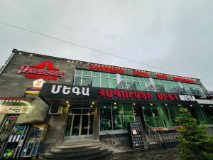 a building with a sign on the front of it at Zangezur Hotel in Goris