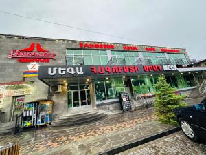 a building on a street in the rain at Zangezur Hotel in Goris