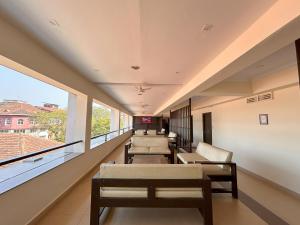 a waiting room with a row of chairs and windows at Hotel Aroma Executive Panaji -Stay in the Heart of the City in Panaji